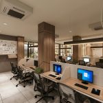 Contemporary open office space with cubicles, computers, and a creative whiteboard wall in a professional setting.